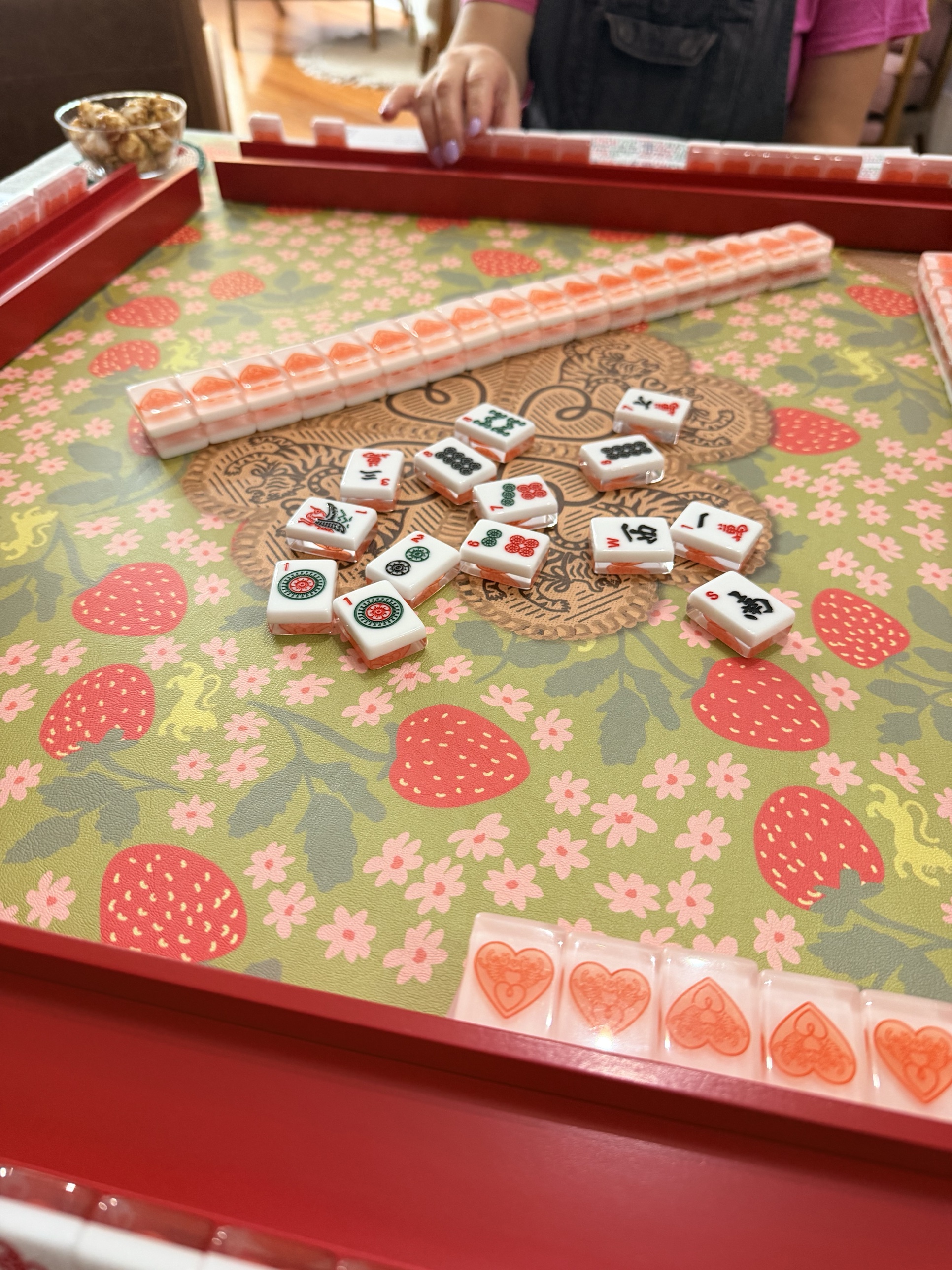Tiles arranged on a strawberry print mat