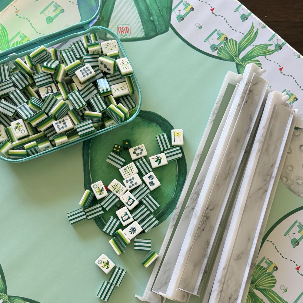 Green and white striped mahjong tiles with marble racks and dice on a golf-themed mat